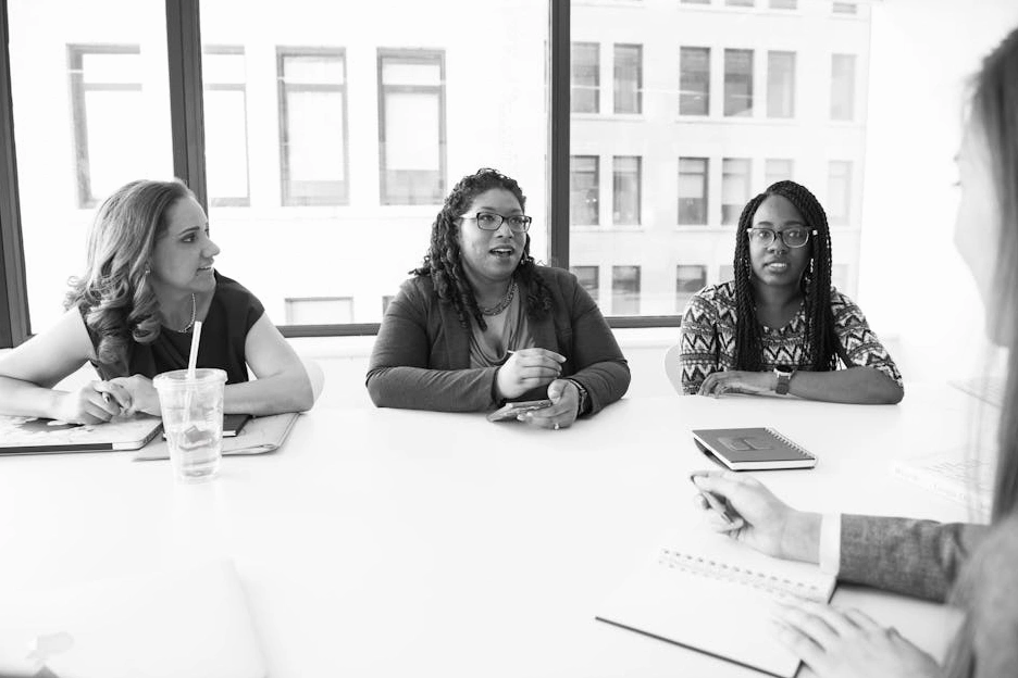 A diverse team of professionals in a strategic meeting at FinTech Bridge Advisors.